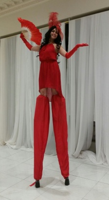 Hala on stilts stunning in red stiltwalker GTA Toronto