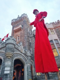 Red tuxedo costume stiltwalker Casa Loma Toronto entertainment on stilts
