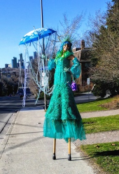 Book Hala on stilts hire stiltwalker stilt walker Toronto GTA April showers green garden costume